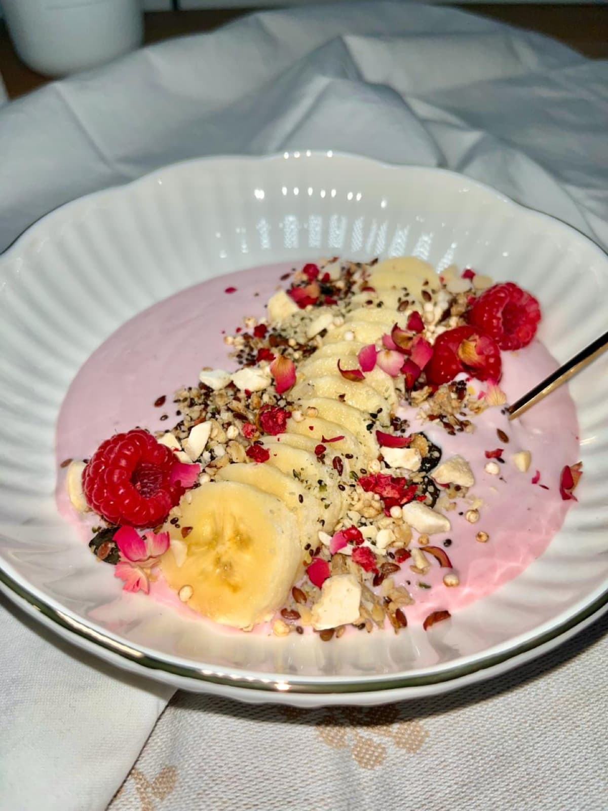 Vegan smoothie bowl with banana, raspberries and granola