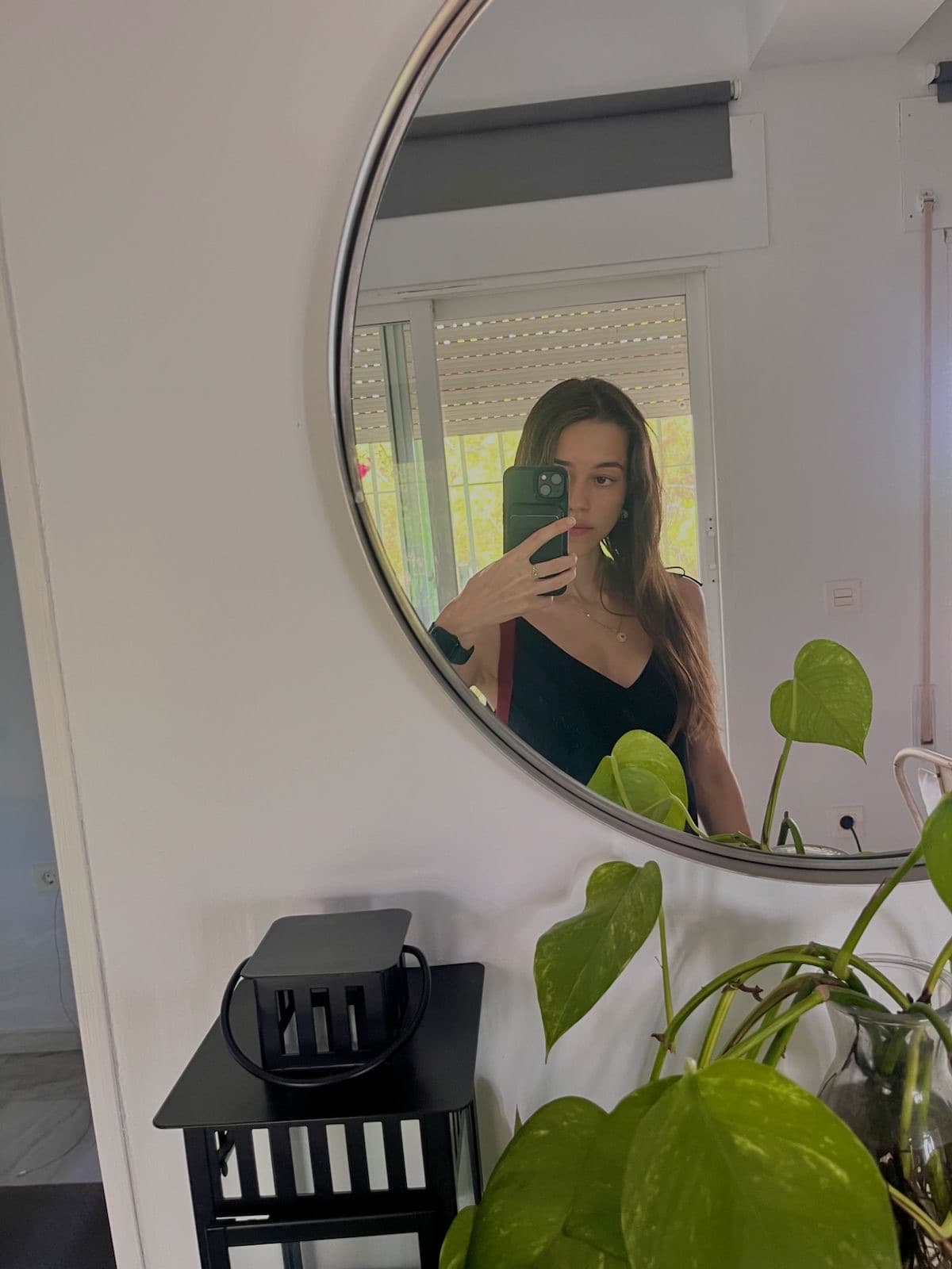 Mirror selfie surrounded by houseplants