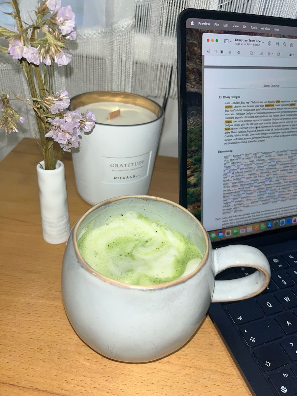 Matcha latte beside a candle while studying